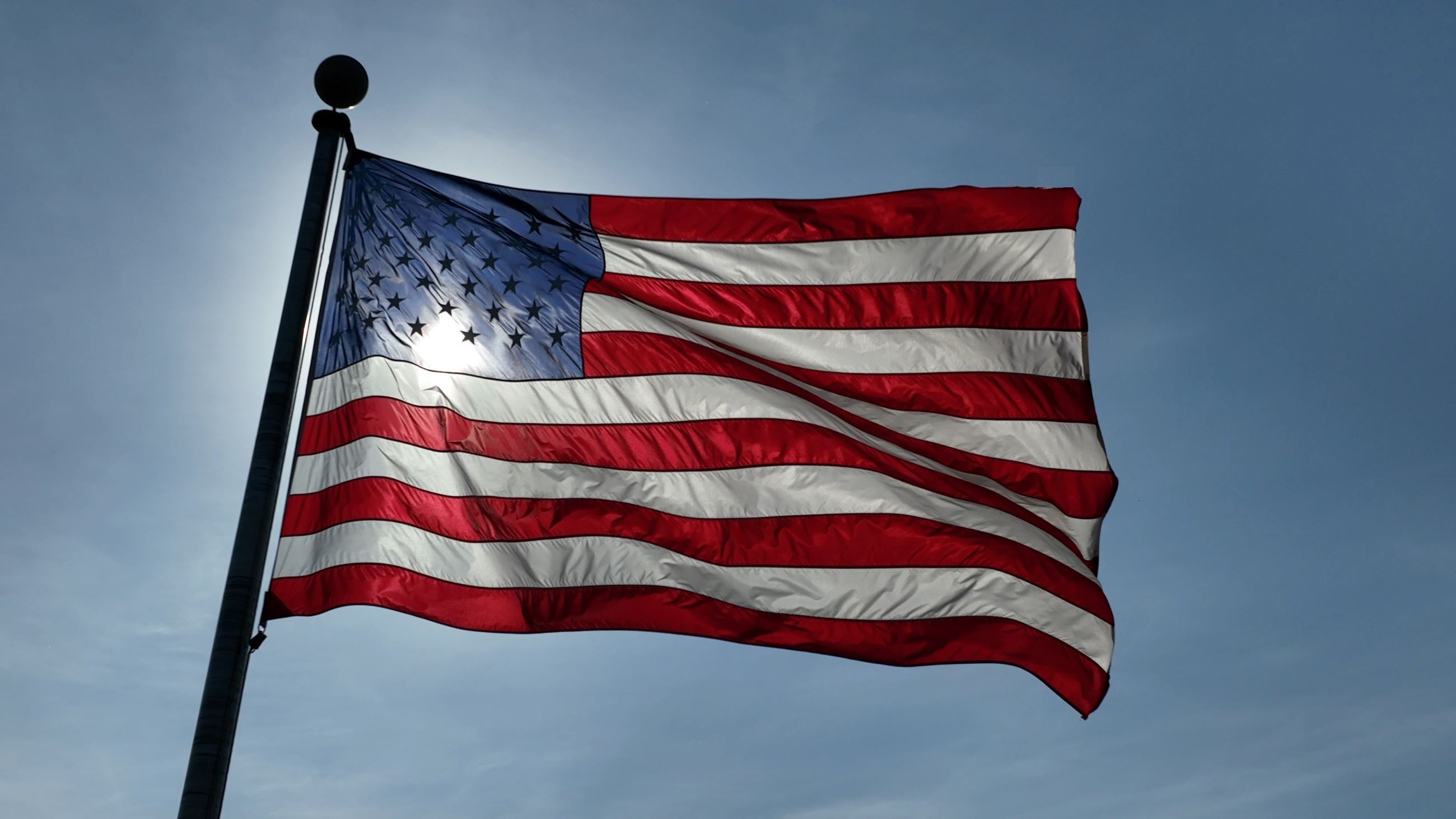 Flag with the sun behind it